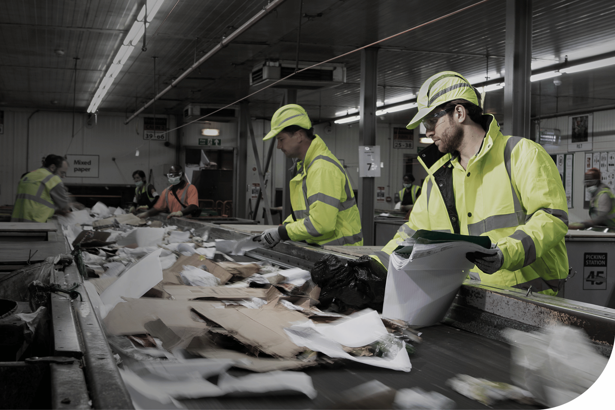 Workers wearing head and hand PPE.