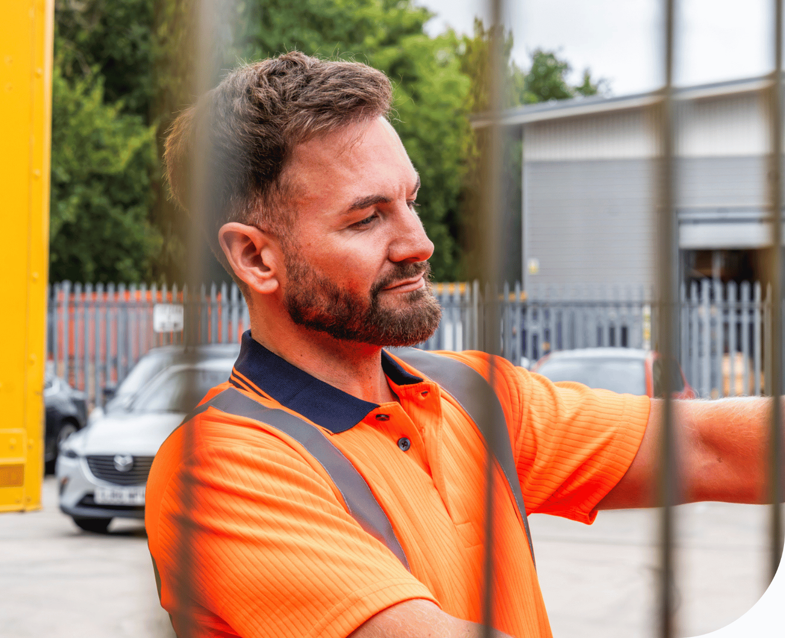 Man wearing orange hi-vis clothing for rail workers.