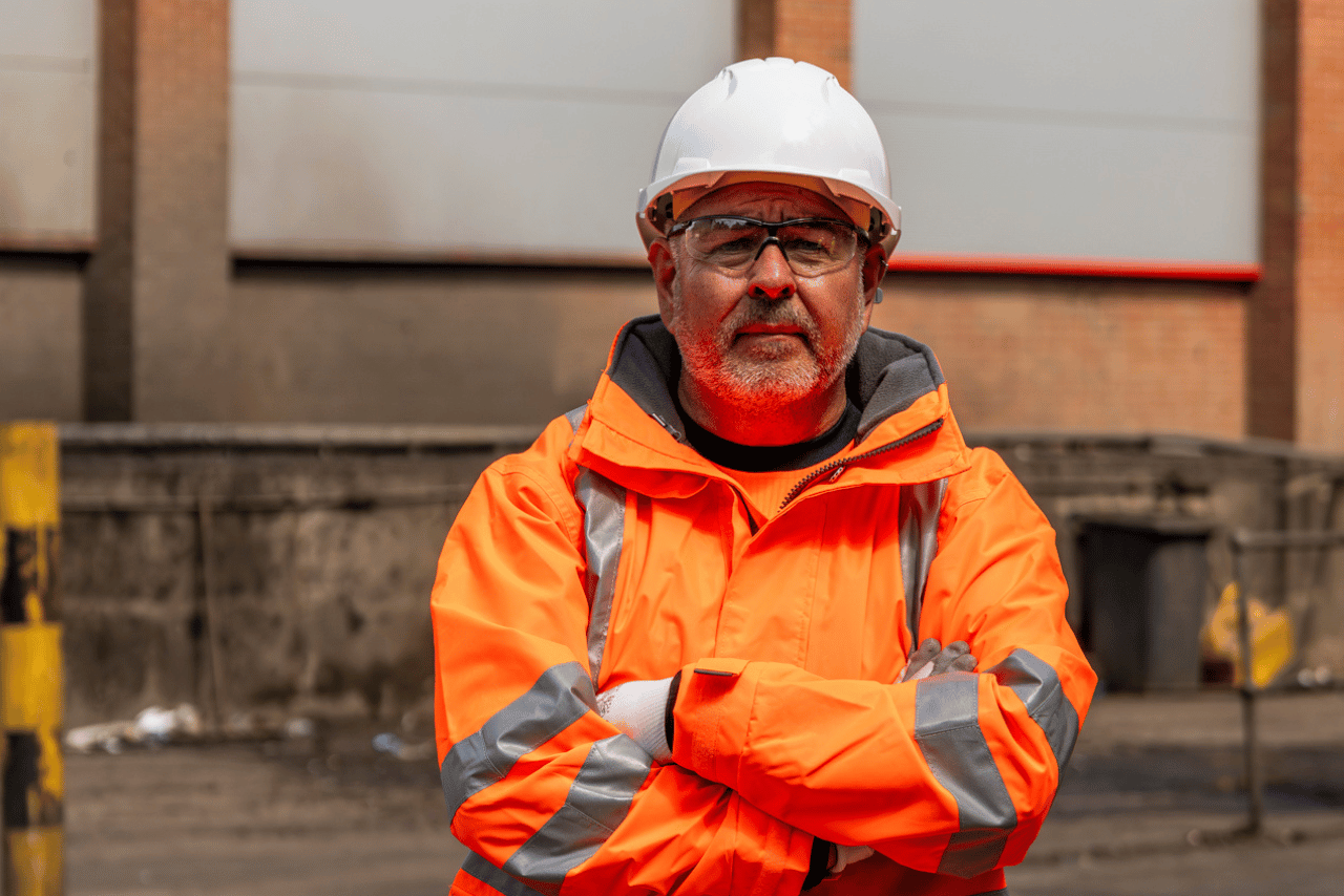 Man in hi-vis orange workwear and a safety helmet.