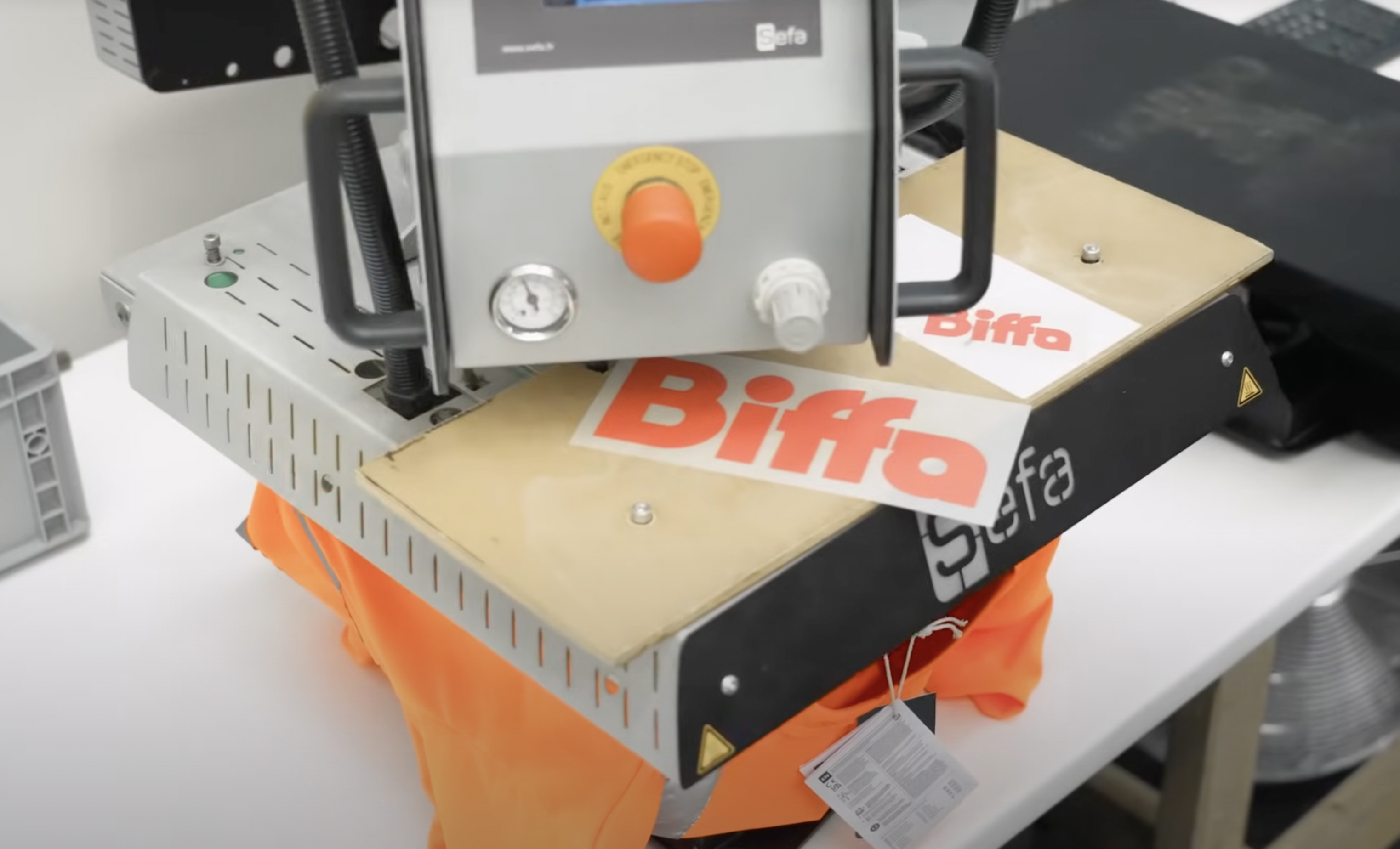 Workwear branding with the Biffa logo.