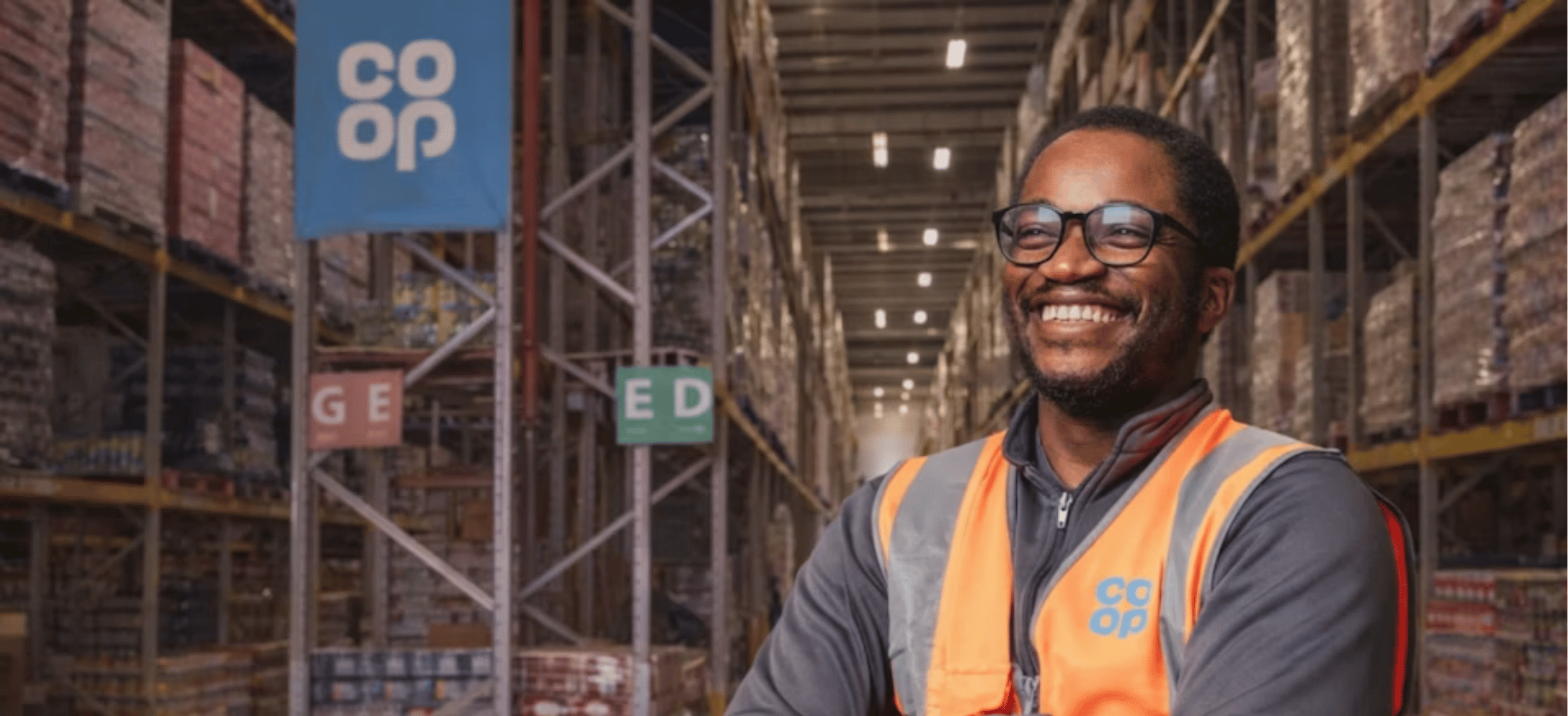 Co-op worker wearing a branded hi-vis vest.